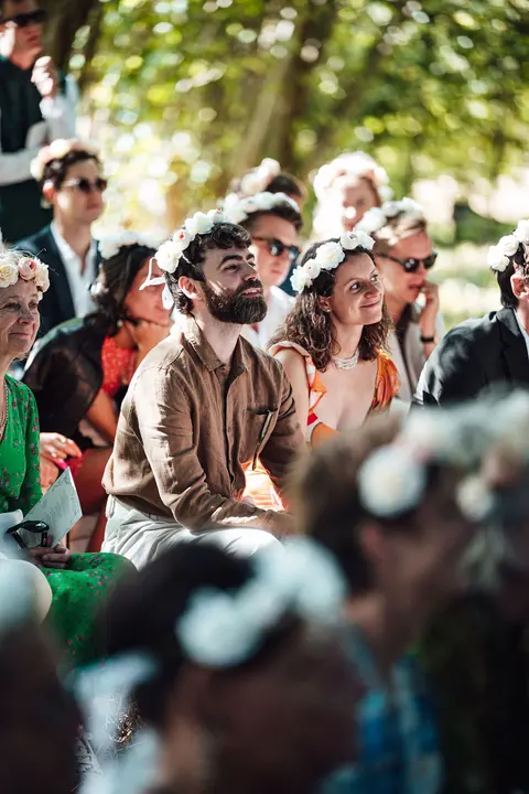 Guests in flower crowns watching the ceremony