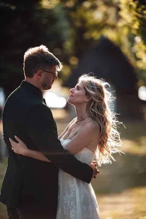 The couple holding each other in the evening sun