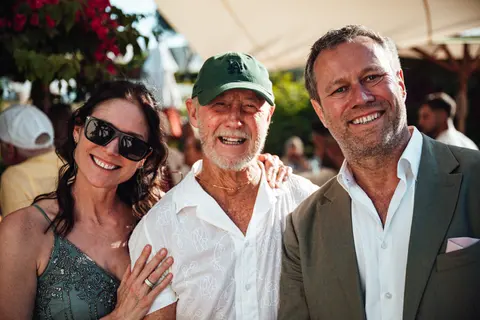 Three guests posing together at the party