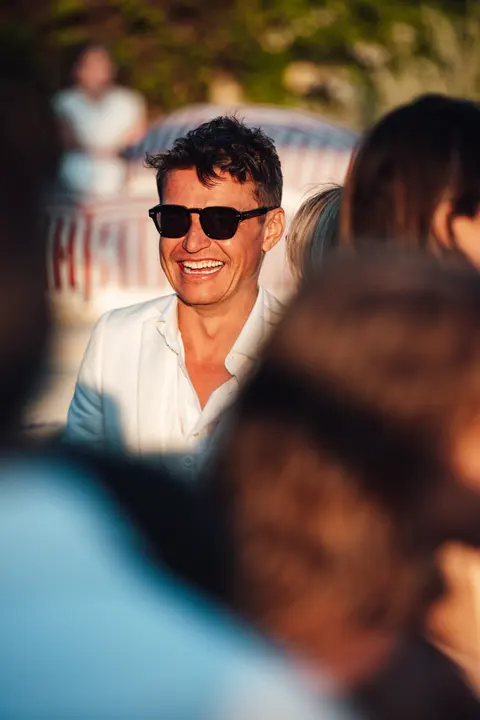 A guest in sunglasses among the crowd