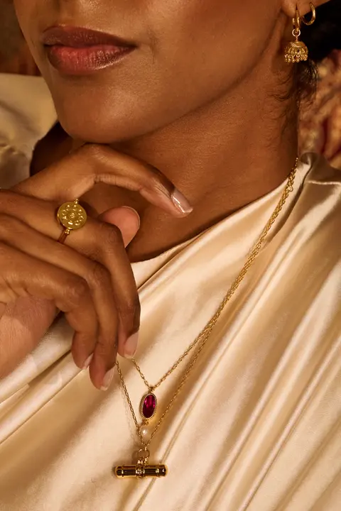 Close portrait of the model's jaw and a delicate pendant