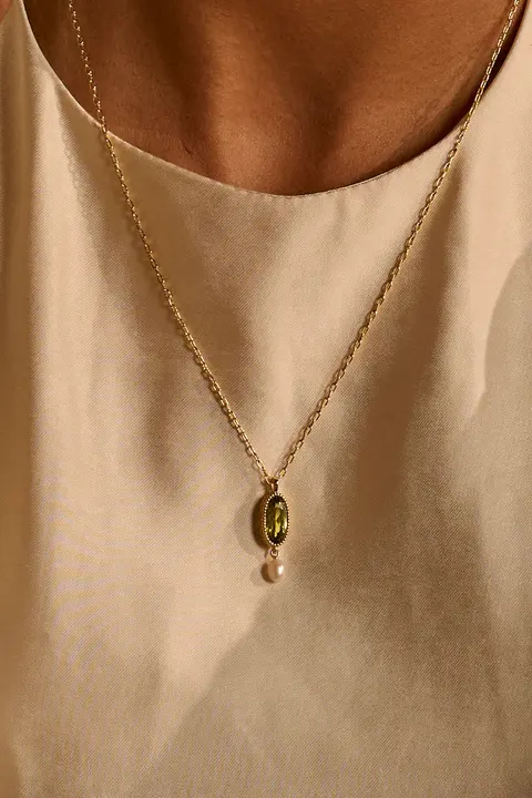 Close detail of a second pendant design on ivory silk