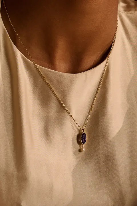 Close detail of a pendant against bare skin