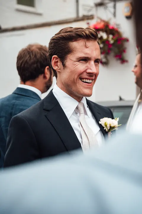 The groom laughing in the street