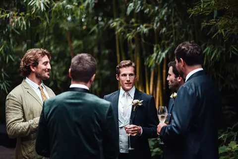 Guests talking in a bamboo garden after the service