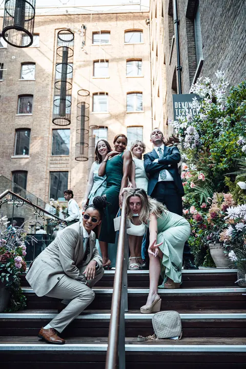The bridal party lounging on the courtyard steps