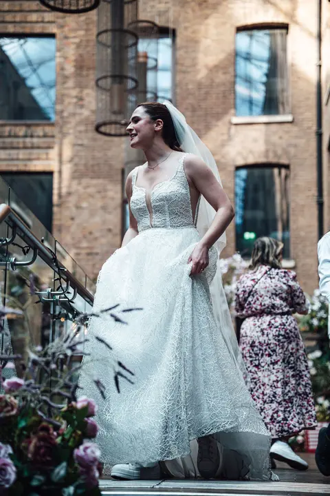 The bride on the courtyard steps looking up
