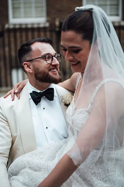 The couple sitting close together, laughing