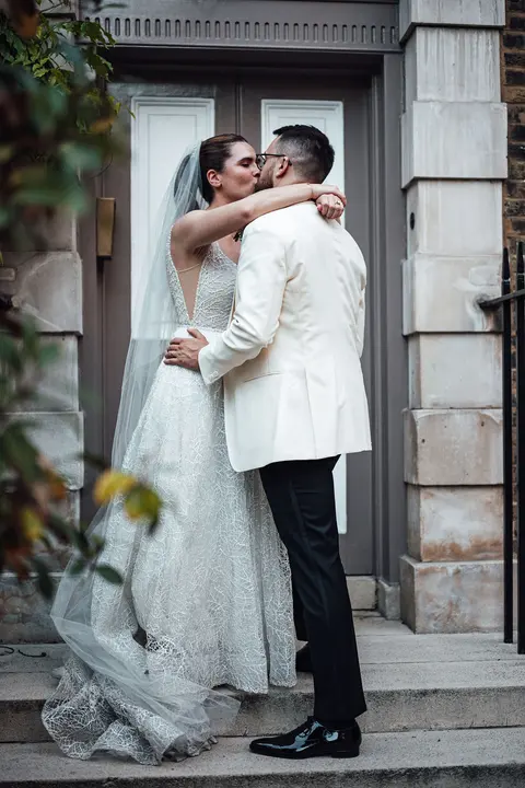 The couple embracing in a doorway