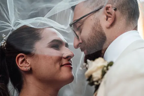 The couple kissing under the veil, another moment
