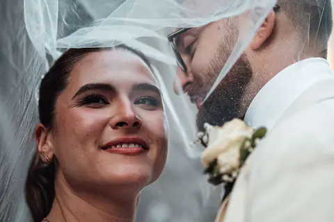 The bride smiling under the veil