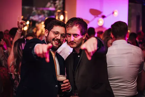 Guests pointing at the camera on the dance floor