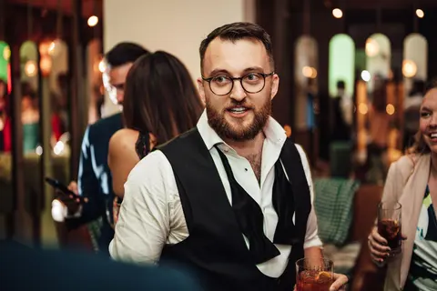 The groom laughing at the party