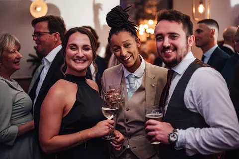 Guests laughing together with drinks