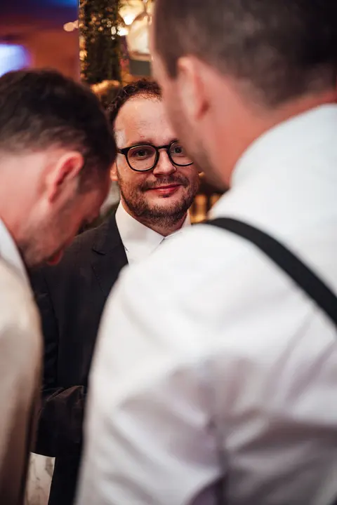 Two guests in conversation at the bar