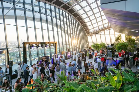 Guests filling the Sky Garden terraces among the plants in evening light