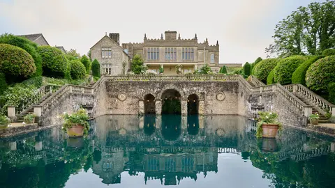 The country house above its reflecting garden pool