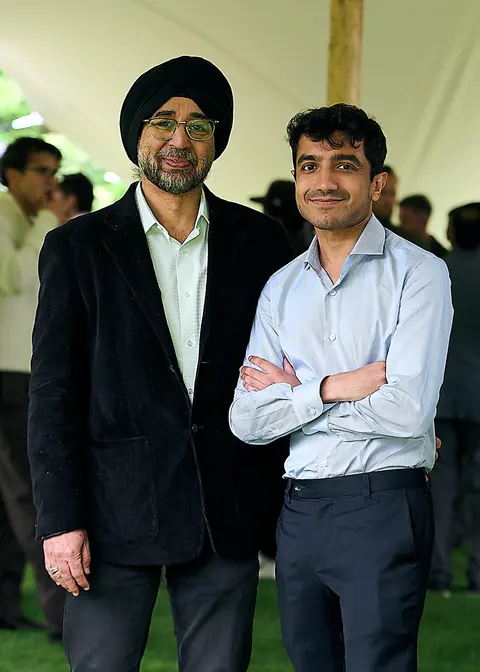 Two guests in turbans posing with arms crossed