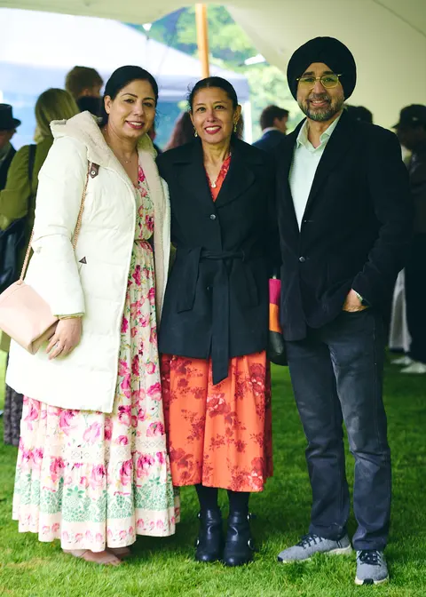 A family group in white and colourful dress under the marquee