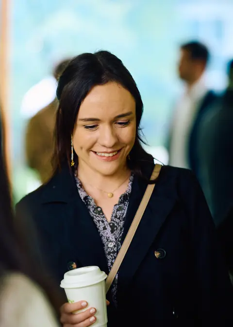 A guest looking down at her coffee cup