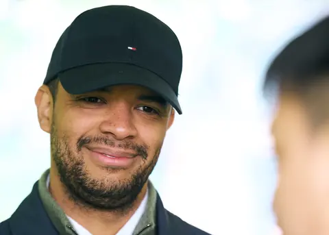 A guest in a black cap, smiling