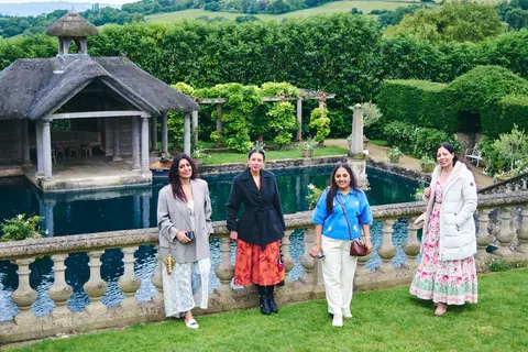 Four guests walking beside the garden pool