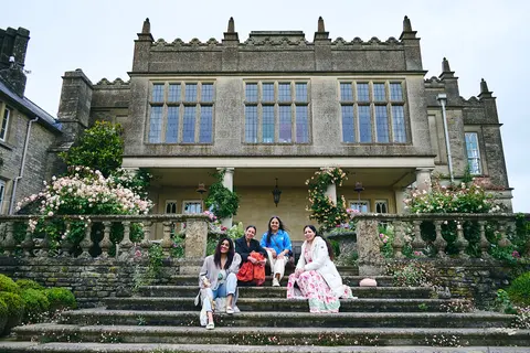 Guests walking down the manor's garden steps
