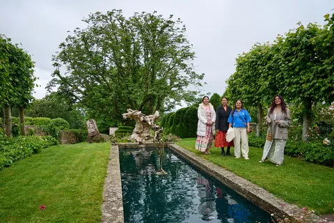 The garden pool and lawn with guests in the distance