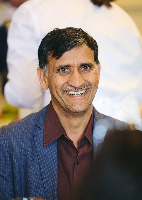 A guest in glasses smiling at the table
