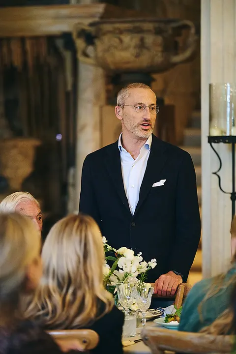 A guest in a suit giving a toast