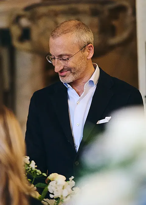 A guest speaking with his hands clasped