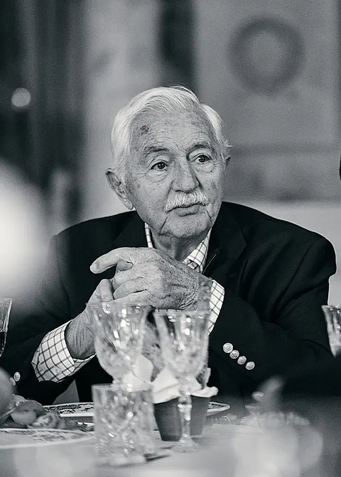 Black and white portrait of an older guest at the table