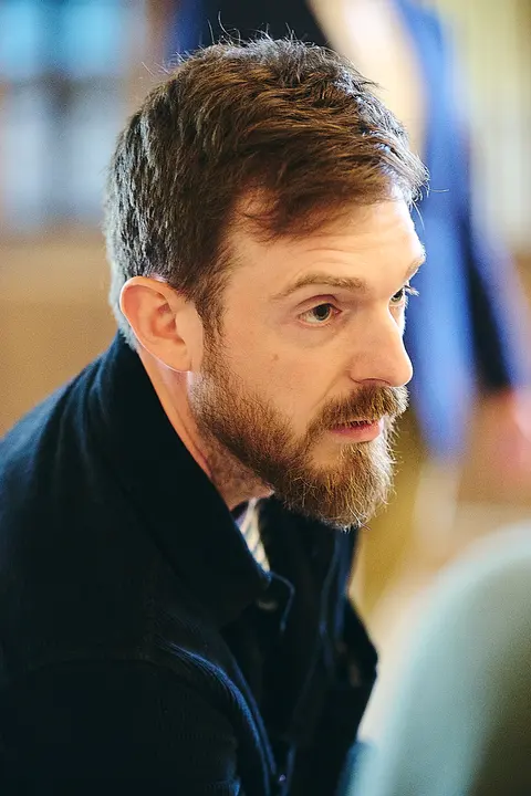 A guest smiling in profile at the table