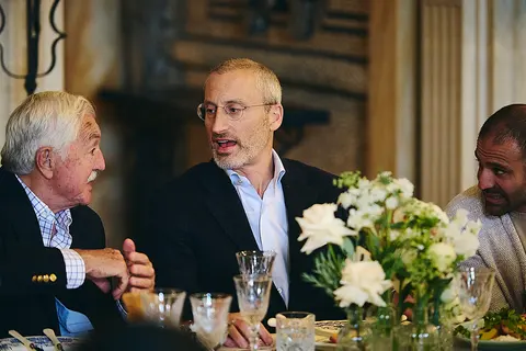 Two guests talking at the table, one older