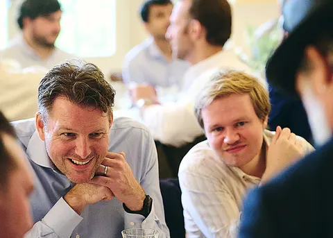 The same two guests laughing, another angle