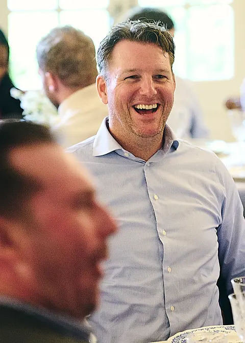 A guest laughing at the table