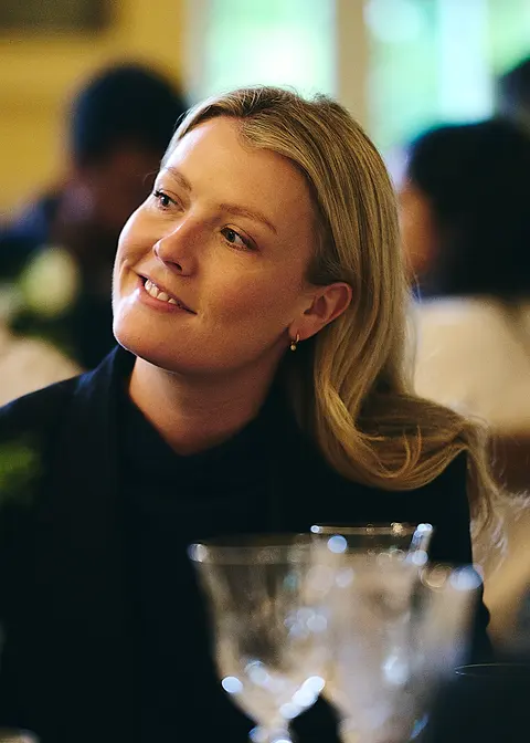 A guest in a cream jumper and necklace