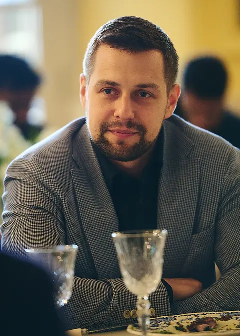 A guest in a grey jumper, portrait