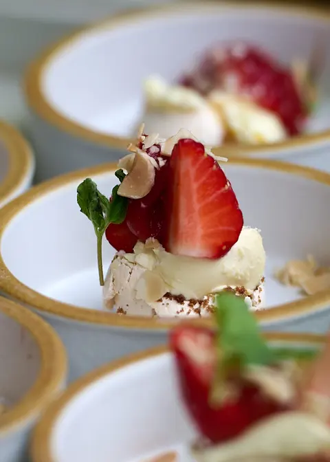 A second plate of strawberries and cream
