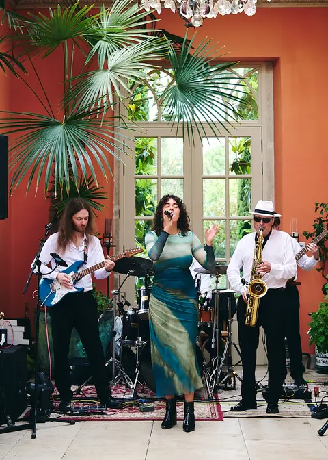 The band performing under the marquee lights