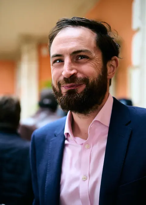 A guest in conversation at the garden party
