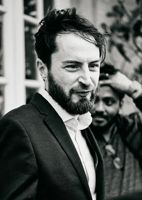 A guest smiling at the end of the evening