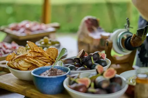 A bowl of green olives on the lunch table