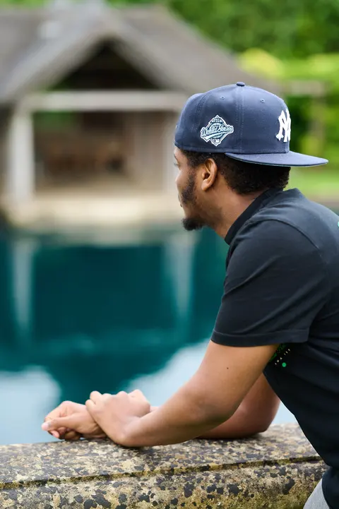 Two young guests in caps talking in the garden