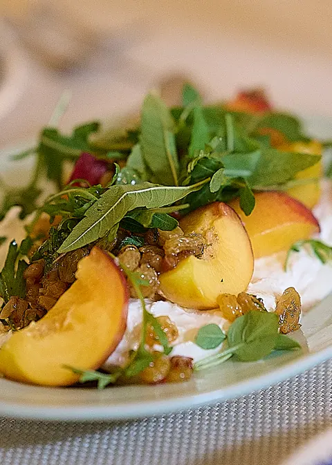 A plate of peaches, rocket and burrata