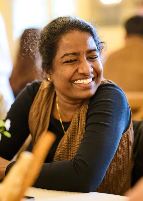 A guest holding up a playing card, laughing