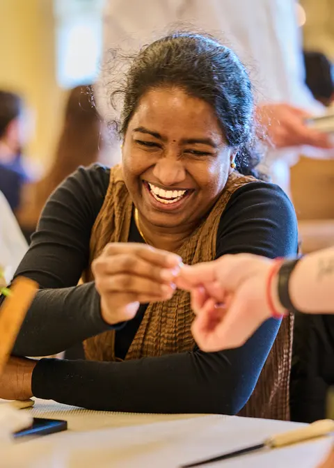 A guest laughing at the card trick