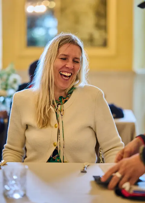 A guest smiling broadly at the lunch table