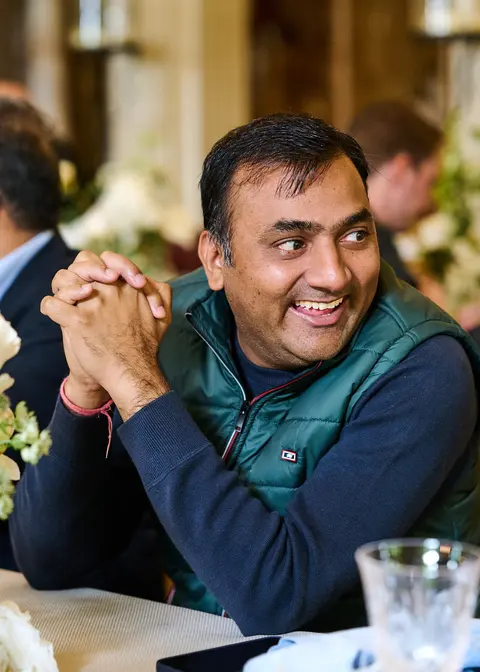 A guest smiling candidly at the table