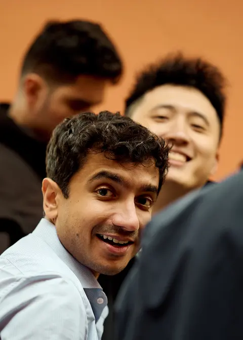 A guest laughing in the drinks reception